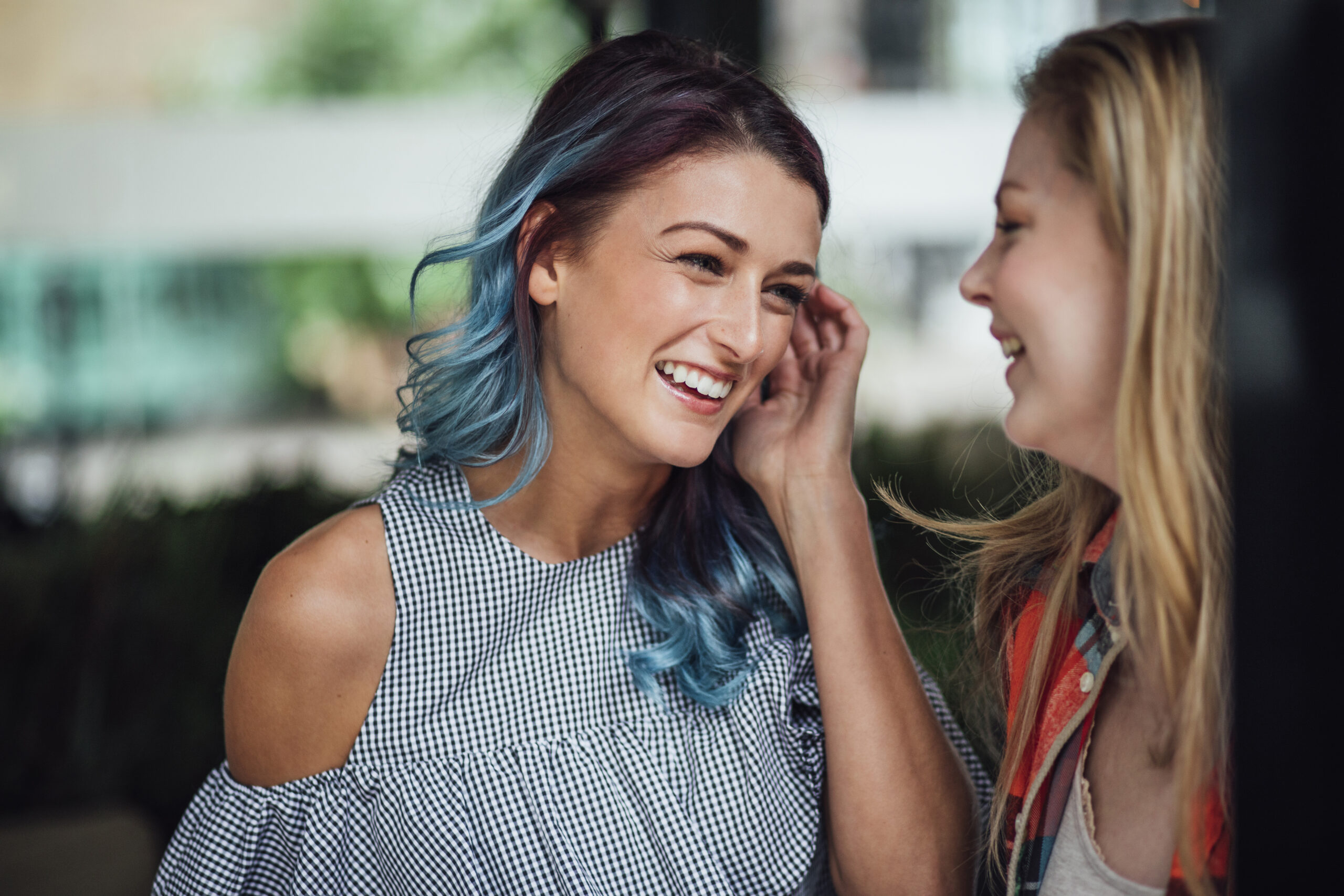 Image of two women speaking to one another